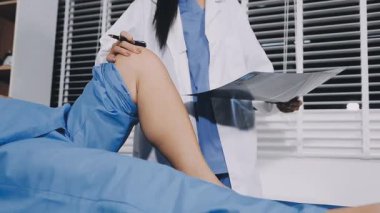 doctor examining patient knee with medical equipment, medical concept