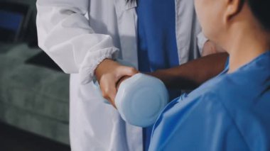 doctor holding patient hand in hospital ward.