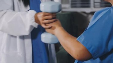 close up of doctor hand holding dumbbells.