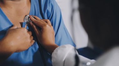 woman doctor is checking heart rate of patient. medical care concept.