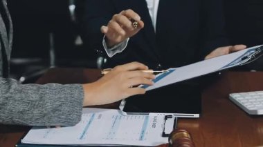 close up of business partners discussing documents at workplace
