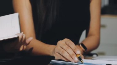 woman hand writing in notebook. woman writing in notebook.