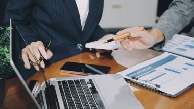 businesswoman working on tablet computer with document in office