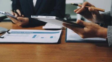 business man holding digital tablet and discussing data on meeting.