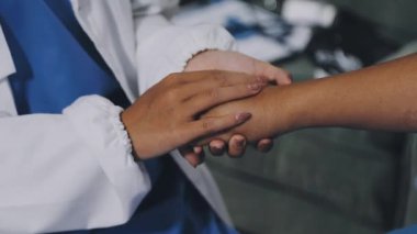 female doctor holding hands in medical uniform