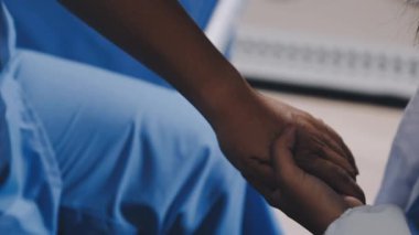 doctor in blue uniform examining patient with hand