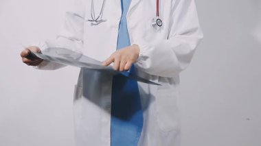 a doctor with a stethoscope in his hands on a white background