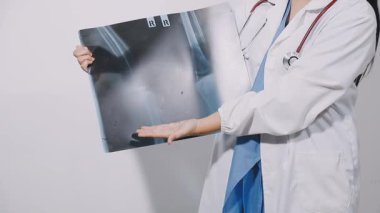 young doctor in white uniform and white medical gown with stethoscope.