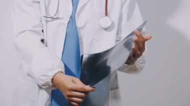 doctor holding x - ray in hands