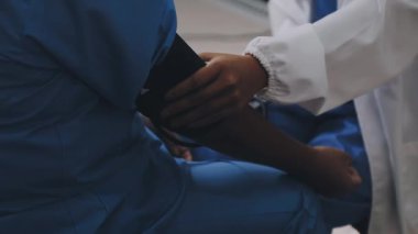 doctor with stethoscope in hands. patient and nurse.