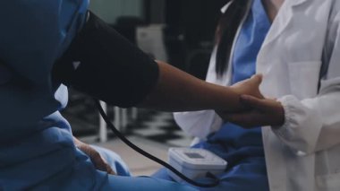 close - up of doctors hand holding heart rate pulse