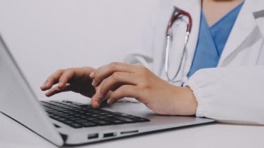 young doctor using a laptop in his office