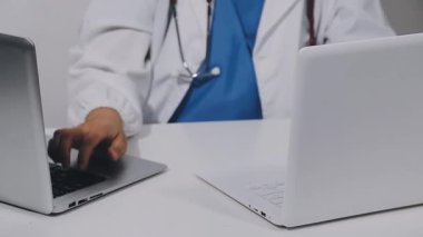 doctor working with laptop in clinic, medical healthcare concept.