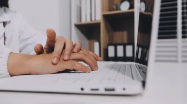 young man typing on a laptop computer.