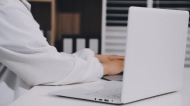 young man doctor using laptop in the hospital.