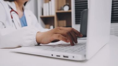 close up view of doctor working on computer at hospital
