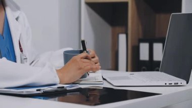 doctor using laptop at workplace in the office