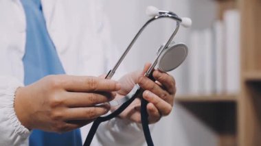 doctor holding medical thoscope in hospital, close up