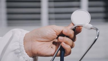doctor hand holding a stethoscope on a white background