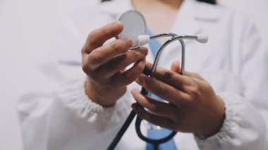 female doctor holding stethoscope and showing her finger.