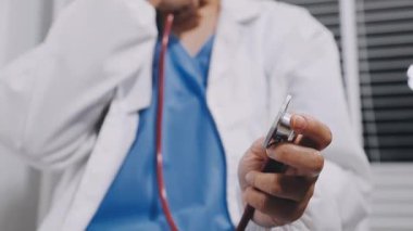 doctor with stethoscope and phone, isolated on white background