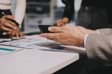 Muhasebe şirketi kazançlı nakit akışı için finansman ve vergilendirme planlaması, ofiste çalışan denetçi ve muhasebeci ekibi, mali verileri ve muhasebe kayıtlarını hesap makinesiyle analiz eder.