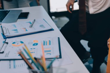 Muhasebe şirketi kazançlı nakit akışı için finansman ve vergilendirme planlaması, ofiste çalışan denetçi ve muhasebeci ekibi, mali verileri ve muhasebe kayıtlarını hesap makinesiyle analiz eder.