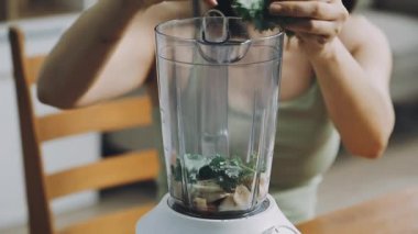 Yemek pişirmek için blender kullanan kadın