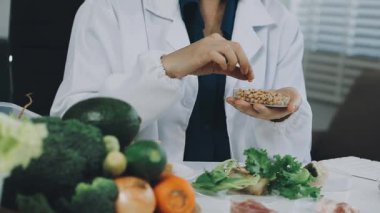 Bıçak ve bir bardak suyla beyaz gömlekli genç bir kadın..