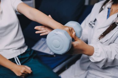 Fizyoterapistle antrenman yapan yaşlı bir kadın. Evde terapist kullanıyor. Huzurevinde yaşlı bir kadına destek oluyor.