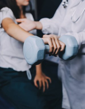 Fizyoterapistle antrenman yapan yaşlı bir kadın. Evde terapist kullanıyor. Huzurevinde yaşlı bir kadına destek oluyor.