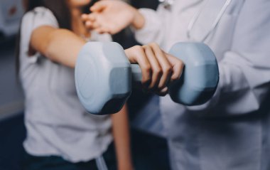 Fizyoterapistle antrenman yapan yaşlı bir kadın. Evde terapist kullanıyor. Huzurevinde yaşlı bir kadına destek oluyor.