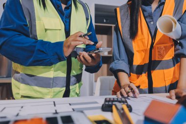 Mimarlar ve mühendisler inşaat projesinde işbirliği içinde çalışıyorlar