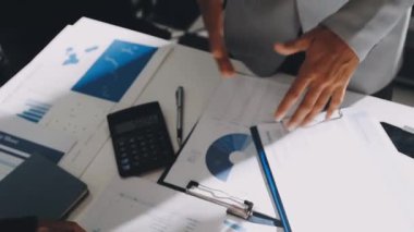 Finans belgesi ve mali muhasebe kavramının rakamlarını hesaplamak için hesap makinesi kullanan bir iş kadını