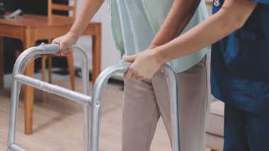 Hemşire kıdemli kadın bacağını muayene ediyor.