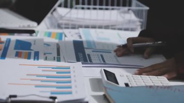 Yatırım sonuçlarını kontrol eden Asyalı erkek finans görevlisi veya muhasebeci, mali bütçe analizi sonuçları özetlemeyi ve denetim konsepti ve yatırım sonuçlarını toplantıya rapor etmeyi planlıyor.