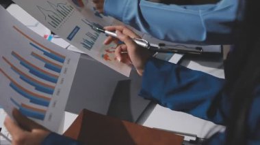 Yatırım sonuçlarını kontrol eden Asyalı erkek finans görevlisi veya muhasebeci, mali bütçe analizi sonuçları özetlemeyi ve denetim konsepti ve yatırım sonuçlarını toplantıya rapor etmeyi planlıyor.