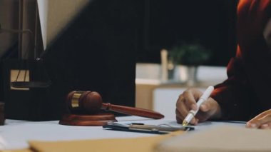 Adalet ve hukuk kavramı. Tahta masadaki bir mahkeme salonunda erkek yargıç ve ofiste çalışan avukat ya da erkek avukat. Hukuk hukuku, tavsiye ve adalet kavramı.