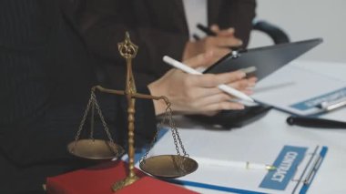 Professional accountants working in a well lit office, analyzing financial data and reviewing statements with a calculator and pen. Audit and taxes theme in business