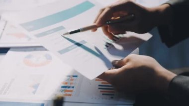 Bir grup menajer iş saatinden sonra akşam saatlerinde takım toplantısı yapıyor. Meslektaşlar Yıllık Finansal ve Pazarlama Raporlarını Tartışıyor. Yaratıcı Ofis 'te takım çalışması. Eller Üzerinde Kapat.