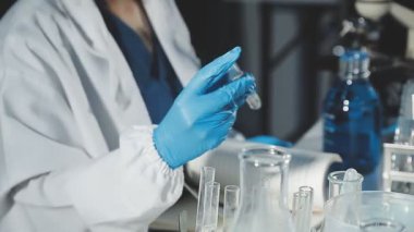 Laboratuarda test tüpleri tutan bilim adamı