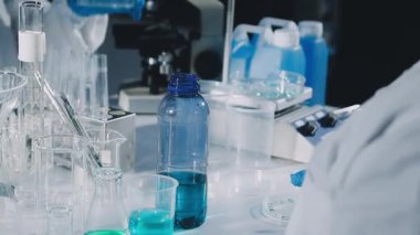 Kapat. Mikroskobu olan laboratuar asistanı.