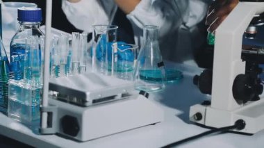 Laboratuvarda deney tüpleri, mikroskop, araştırma, geliştirme ve bir kimya laboratuvarında araştırma yapan bilim adamı..