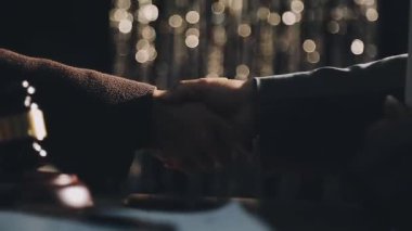 Sahnede mikrofonu olan siyah ceketli genç bir adamın elleri..