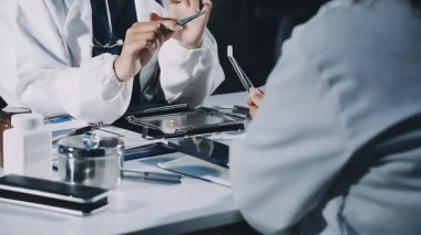 Tıbbi bir laboratuvarda steteskopla beyaz önlüklü bir erkek doktorun fotoğrafını çek..