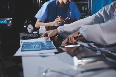 Doktorlar tedavi seçeneklerini tartışmak ve iş arkadaşlarıyla deneyimleri paylaşmak için hastanede toplanıyorlar.