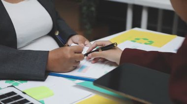 businessmen are analyzing data on a paper sheet in office. business and financial concept