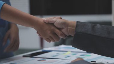 business people shaking hands after meeting at the office