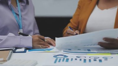young businesswoman in formal clothes discussing new business charts and graphs in the office. teamwork and planning concept.