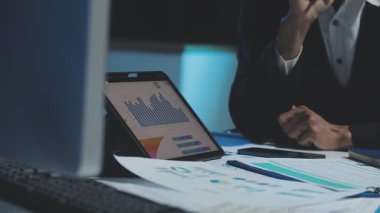 business man hand using laptop computer on desk in modern office with diagram